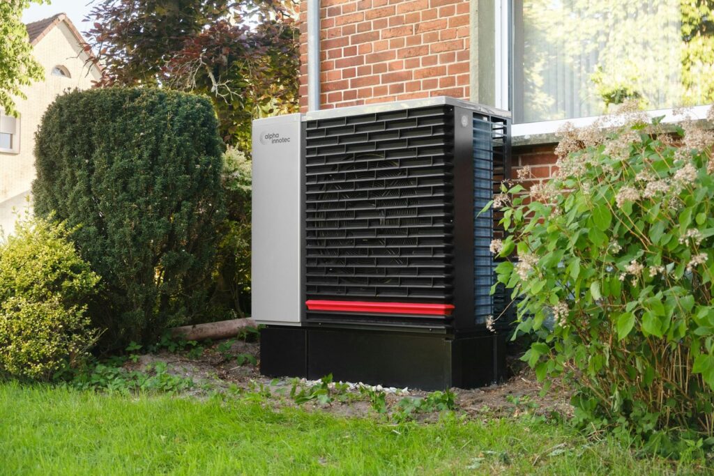 Heat pump unit outside a brick house