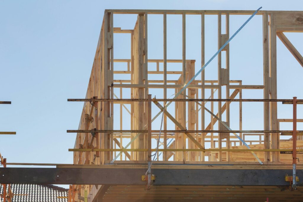 Timber frame house under construction with scaffolding